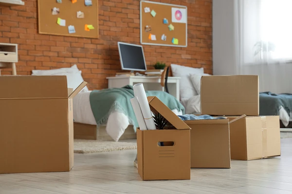 Apartment bedroom with cardboard boxes packed